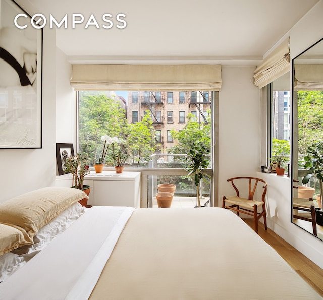 425 E 13th St Unit 3F, New York City, NY 10009 - bedroom featuring wood finished floors and multiple windows