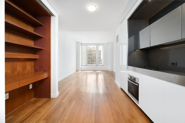 15 William St Unit 39F, New York City, NY 10004 - unfurnished living room featuring light wood-type flooring