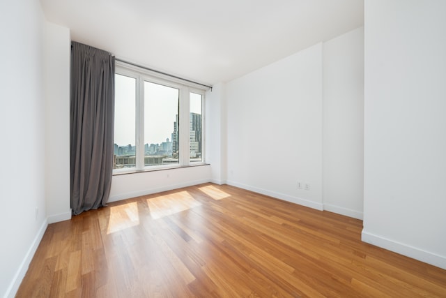 15 William St Unit 39F, New York City, NY 10004 - spare room featuring light wood finished floors and baseboards