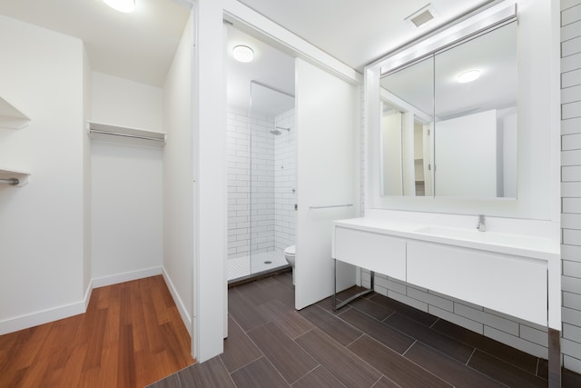 15 William St Unit 39F, New York City, NY 10004 - bathroom with a stall shower, wood finished floors, and vanity