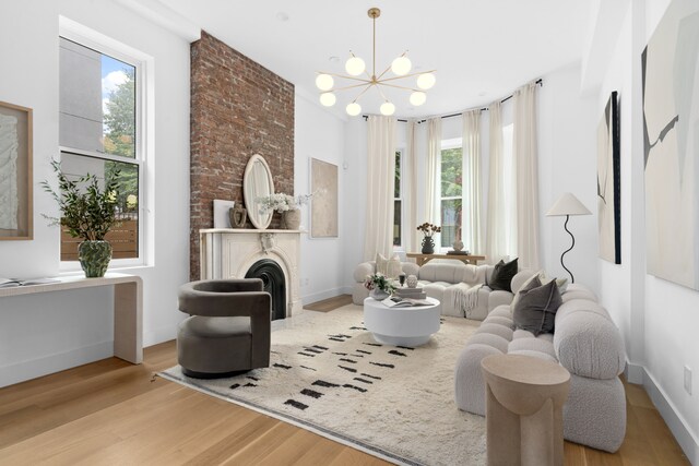 205 14th St Unit Th, New York City, NY 11215 - living room featuring wood finished floors, a chandelier, and a fireplace