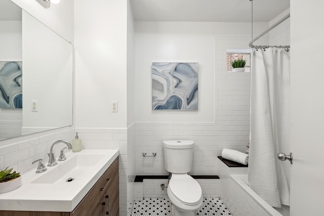 222 E 17th St Garden, Unit Garden, New York City, NY 10003 - bathroom with tile walls, vanity, tiled shower / bath, tile patterned floors, and a wainscoted wall