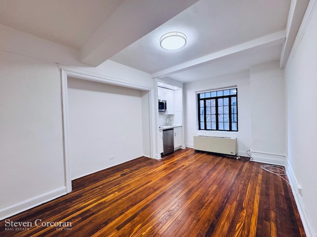 5 Tudor City Pl Unit 1510, New York City, NY 10017 - spare room with dark wood finished floors, radiator, and beamed ceiling