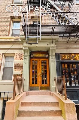 204 W 10th St Unit 18, New York City, NY 10014 - doorway to property with french doors, a balcony, and brick siding