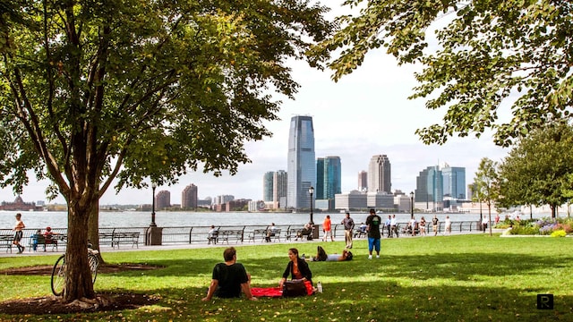 2 River Ter Unit 9-A, New York City, NY 10282 - view of property's community featuring a view of skyline, a water view, and a lawn