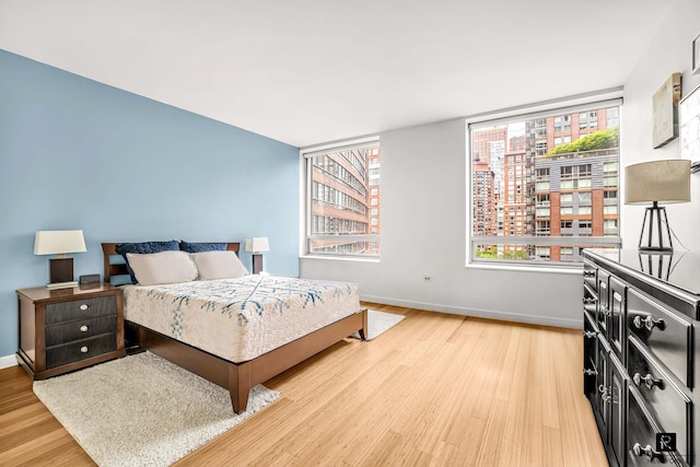 2 River Ter Unit 9-A, New York City, NY 10282 - bedroom with baseboards and light wood-style floors