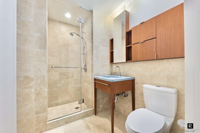 2 River Ter Unit 9-A, New York City, NY 10282 - bathroom with a stall shower, tile walls, and tile patterned flooring