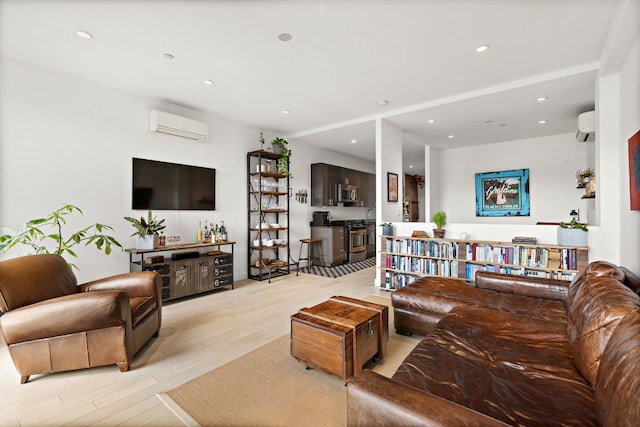 148 W 121st St Unit 5, New York City, NY 10027 - living area featuring a wall unit AC, light wood-style floors, and recessed lighting