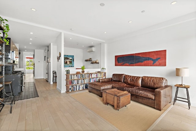 148 W 121st St Unit 5, New York City, NY 10027 - living area featuring a wall unit AC, light wood-style flooring, and recessed lighting