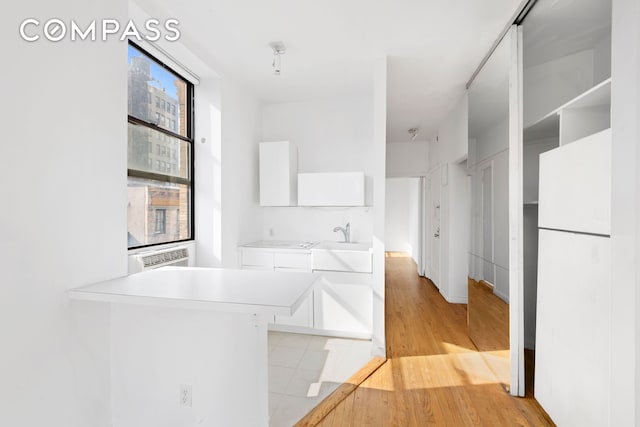 214 Mulberry St Unit 6B, New York City, NY 10012 - corridor featuring light wood finished floors and a sink