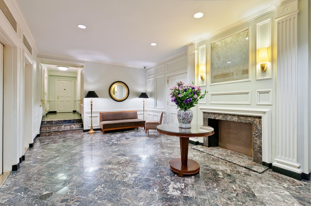 59 W 12th St Unit 4H, New York City, NY 10011 - bedroom with a decorative wall, ornamental molding, marble tiled floors, a premium fireplace, and recessed lighting