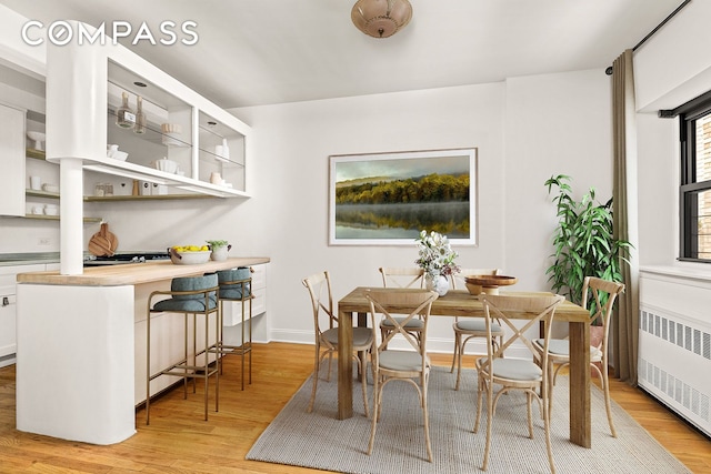 689 Fort Washington Ave Unit 1Aa, New York City, NY 10040 - dining room featuring radiator and light wood-style flooring