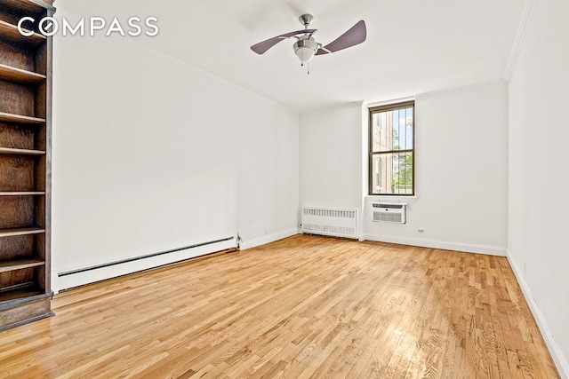 689 Fort Washington Ave Unit 1Aa, New York City, NY 10040 - spare room featuring baseboard heating, radiator heating unit, crown molding, wood finished floors, and a ceiling fan