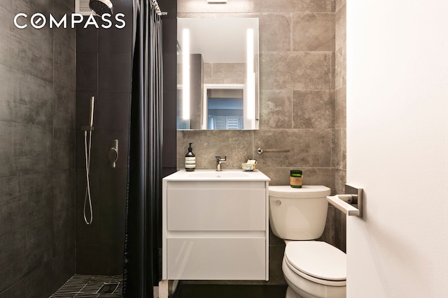 101 W 12th St Unit 6L, New York City, NY 10011 - bathroom with tiled shower, vanity, tile walls, and tasteful backsplash