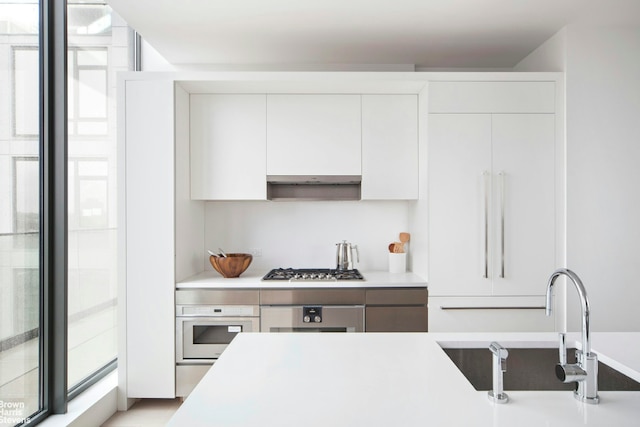 251 1st St Unit Ph8D, New York City, NY 11215 - kitchen with oven, light countertops, white cabinetry, and modern cabinets