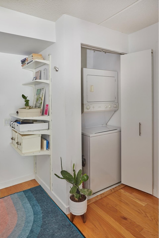 555 W 23rd St Unit N7H, New York City, NY 10011 - washroom with estacked washer and dryer and wood finished floors