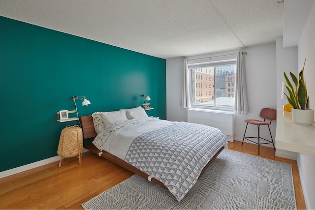 555 W 23rd St Unit N7H, New York City, NY 10011 - bedroom featuring a textured ceiling and wood finished floors