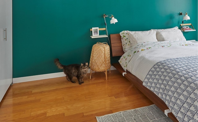 555 W 23rd St Unit N7H, New York City, NY 10011 - bedroom featuring baseboards and wood finished floors