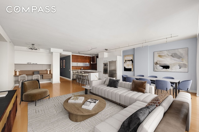 151 W 17th St Unit 5A, New York City, NY 10011 - living area featuring track lighting and light wood-style floors