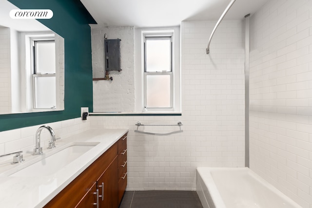 37-16 80th St Unit 1, New York City, NY 11372 - bathroom featuring vanity, tile walls, shower / washtub combination, and tile patterned flooring