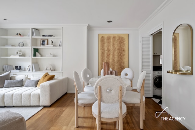 112 E 83rd St Unit 7A, New York City, NY 10028 - dining room featuring washer / clothes dryer, light wood finished floors, and ornamental molding