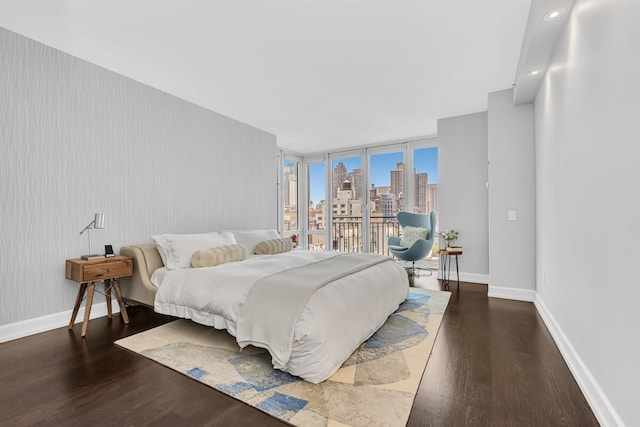 408 E 79th St Unit 8B, New York City, NY 10021 - bedroom with a view of skyline and wood finished floors