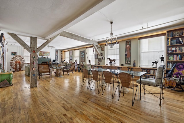 200 Mercer St Unit Ph4C, New York City, NY 10012 - dining area featuring healthy amount of natural light, hardwood / wood-style floors, and beam ceiling