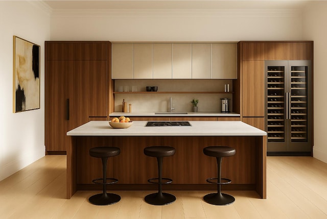 200 Mercer St Unit Ph4C, New York City, NY 10012 - kitchen featuring modern cabinets, stovetop, light countertops, a kitchen bar, and ornamental molding