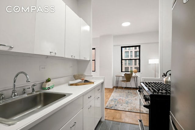 201 E 21st St Unit 15C, New York City, NY 10010 - kitchen featuring appliances with stainless steel finishes, white cabinets, light countertops, and recessed lighting