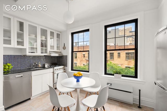 170 2nd Ave Unit 5C, New York City, NY 10003 - kitchen featuring dishwasher, gas stove, dark countertops, and healthy amount of natural light