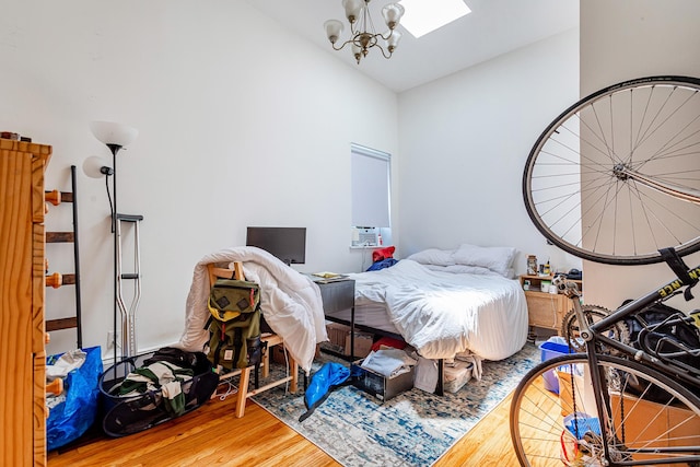 298 12th St Unit 4F, New York City, NY 11215 - bedroom with wood finished floors, a chandelier, vaulted ceiling, and a skylight