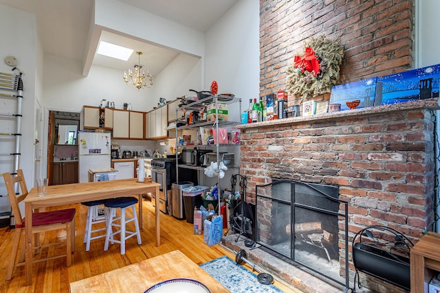 298 12th St Unit 4F, New York City, NY 11215 - dining room featuring light wood-style floors, a chandelier, brick wall, and a skylight