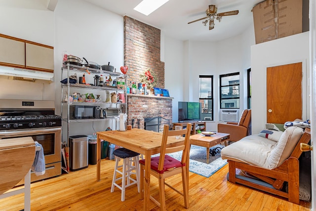 298 12th St Unit 4F, New York City, NY 11215 - living area featuring wood-type flooring, ceiling fan, a high ceiling, and cooling unit