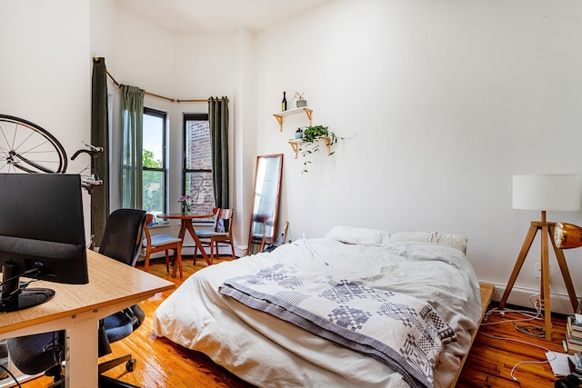 298 12th St Unit 4F, New York City, NY 11215 - bedroom featuring baseboard heating, wood finished floors, and an office area