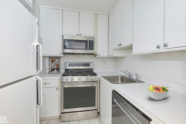 330 3rd Ave Unit 3K, New York City, NY 10010 - kitchen featuring appliances with stainless steel finishes, light countertops, white cabinets, and light tile patterned floors