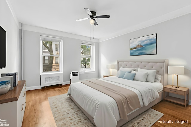 320 E 83rd St Unit 2B, New York City, NY 10028 - bedroom featuring radiator, light wood-style floors, and ceiling fan