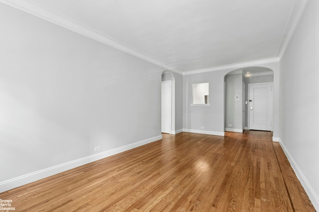 320 E 83rd St Unit 2B, New York City, NY 10028 - empty room featuring arched walkways, light wood-style floors, and ornamental molding