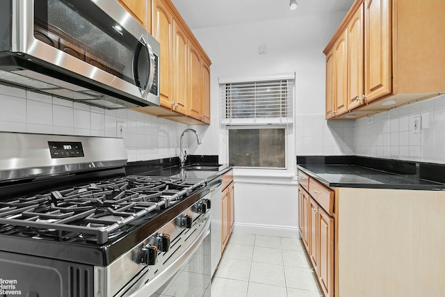 320 E 83rd St Unit 2B, New York City, NY 10028 - kitchen with stainless steel appliances, decorative backsplash, and light tile patterned floors