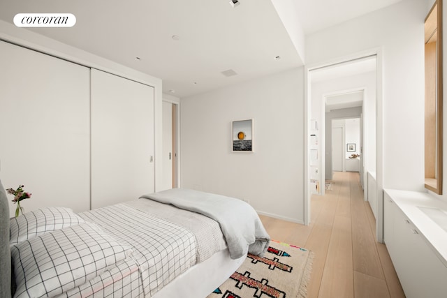 270 Broadway Unit 18C, New York City, NY 10007 - bedroom featuring light wood-type flooring and a closet