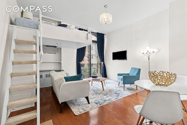 215 E 24th St Unit 412A, New York City, NY 10010 - living area featuring wood finished floors, a chandelier, and a wall mounted air conditioner