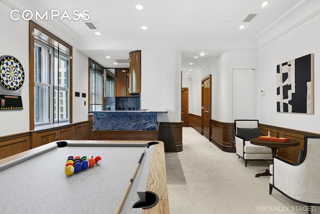 781 5th Ave Unit 17, New York City, NY 10022 - recreation room with crown molding, wainscoting, light carpet, recessed lighting, and a decorative wall