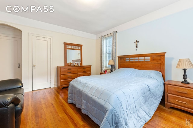 79-15 35th Ave Unit 3E, New York City, NY 11372 - bedroom featuring light wood-type flooring and arched walkways