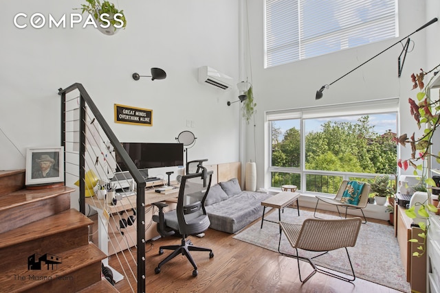 299 Van Buren St Unit 4C, New York City, NY 11221 - office area with a high ceiling, wood finished floors, and a wall mounted AC