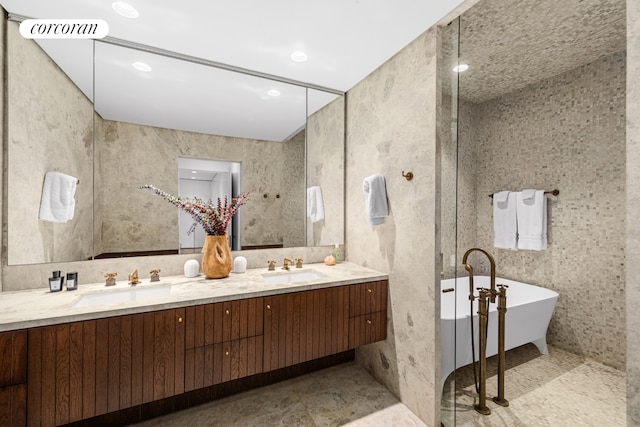 527 W 27th St Unit 3A, New York City, NY 10001 - full bath featuring double vanity, a soaking tub, recessed lighting, and tile patterned flooring