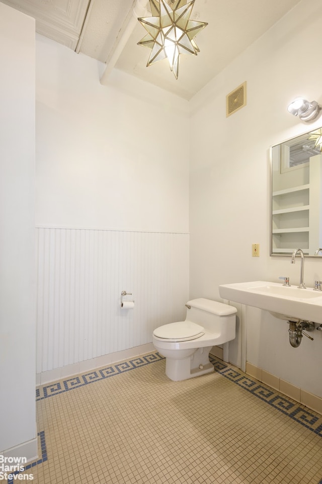 547 Broadway Unit 3, New York City, NY 10012 - half bath with toilet and a wainscoted wall