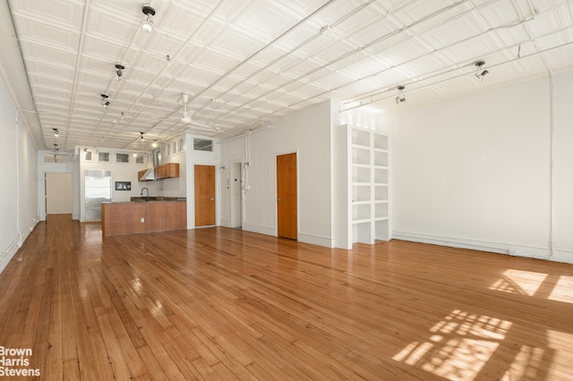 547 Broadway Unit 3, New York City, NY 10012 - unfurnished living room with light wood finished floors and a sink