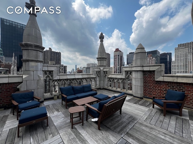 25 Tudor City Pl Unit 1405, New York City, NY 10017 - wooden terrace with outdoor lounge area and a skyline view