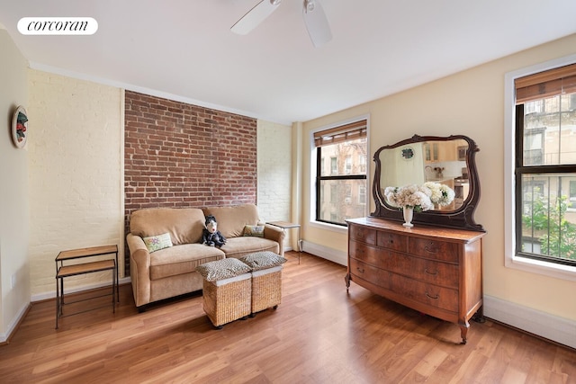 446 W 47th St Unit 3C, New York City, NY 10036 - sitting room featuring brick wall, light wood finished floors, and ceiling fan