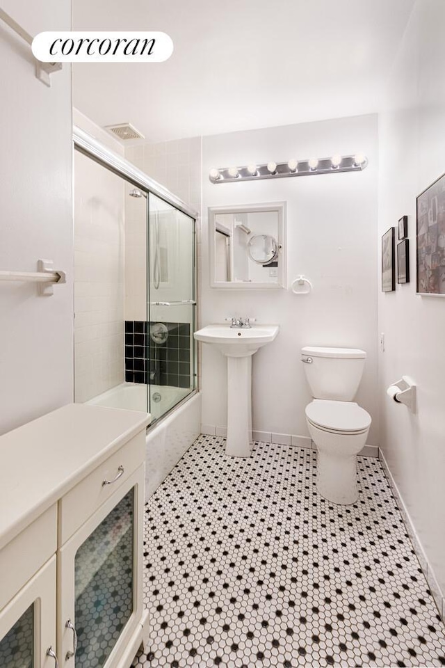 446 W 47th St Unit 3C, New York City, NY 10036 - bathroom featuring toilet and enclosed tub / shower combo