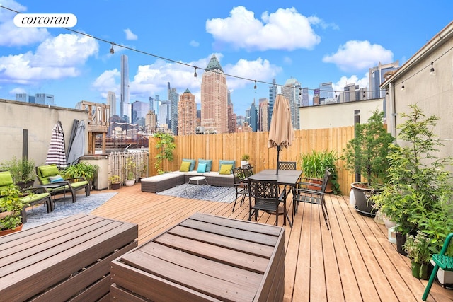446 W 47th St Unit 3C, New York City, NY 10036 - wooden terrace featuring a view of skyline and outdoor dining space